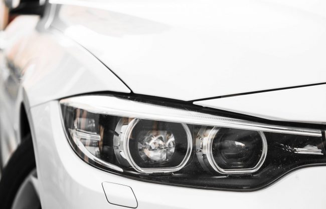 Closeup of car headlight illustrates blog "How to Protect Your Car From Dings and Scratches"