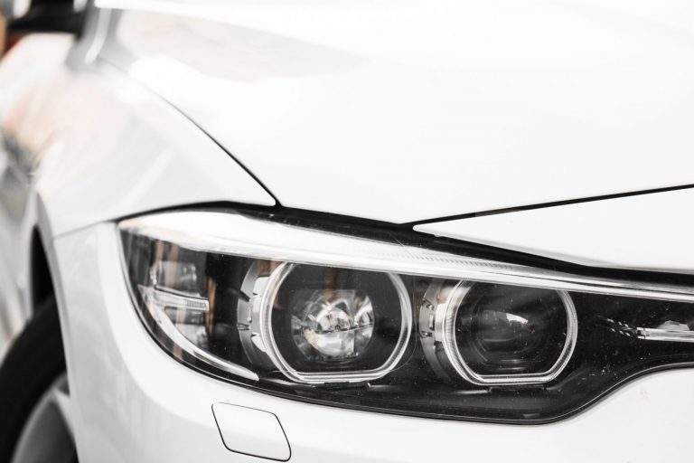 Closeup of car headlight illustrates blog "How to Protect Your Car From Dings and Scratches"