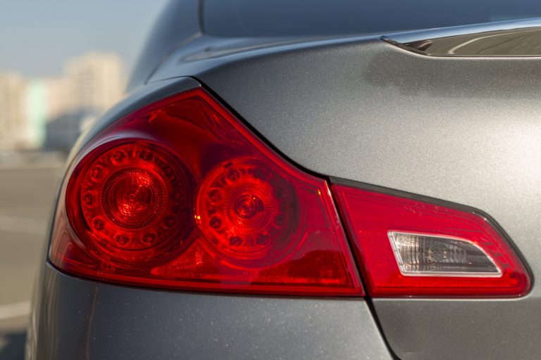 Tail lights of silver car illustrate blog "Can You Fix a Tail Light By Yourself?"