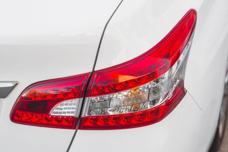 Rear bumper of white car seen from above illustrates blog “Why Is My Rear Bumper Loose? All You Need to Know"