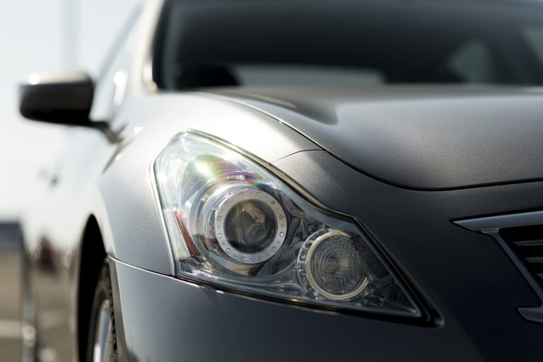 Closeup of hood of gray car.